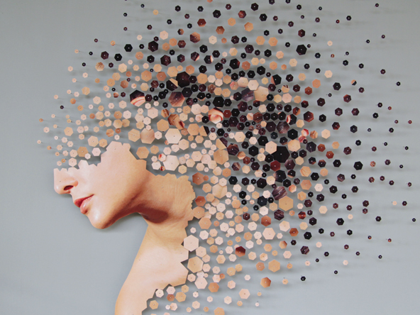 an image of a woman with the top of her head fragmenting into small hexagons