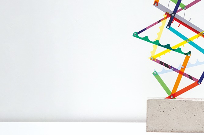 sculpture of colourful shapes on a concrete brick base