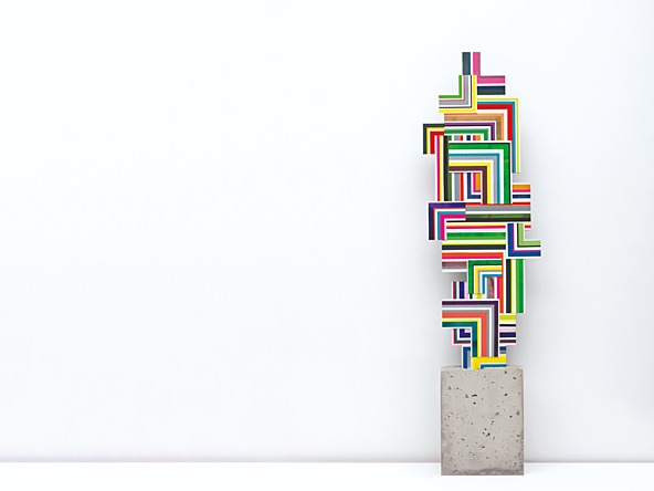 sculpture of colourful shapes on a concrete brick base