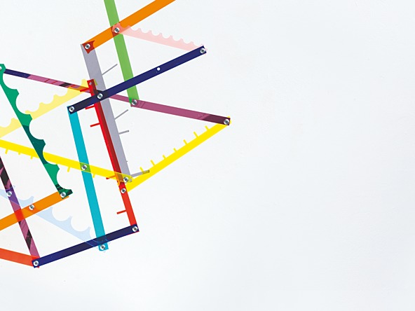 sculpture of colourful shapes on a concrete brick base